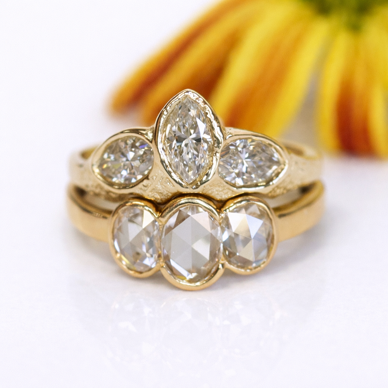 Custom gold ring set with marquise and oval cut diamonds, handcrafted by Alexis Pavlantos, featuring soft organic forms and layered settings.
