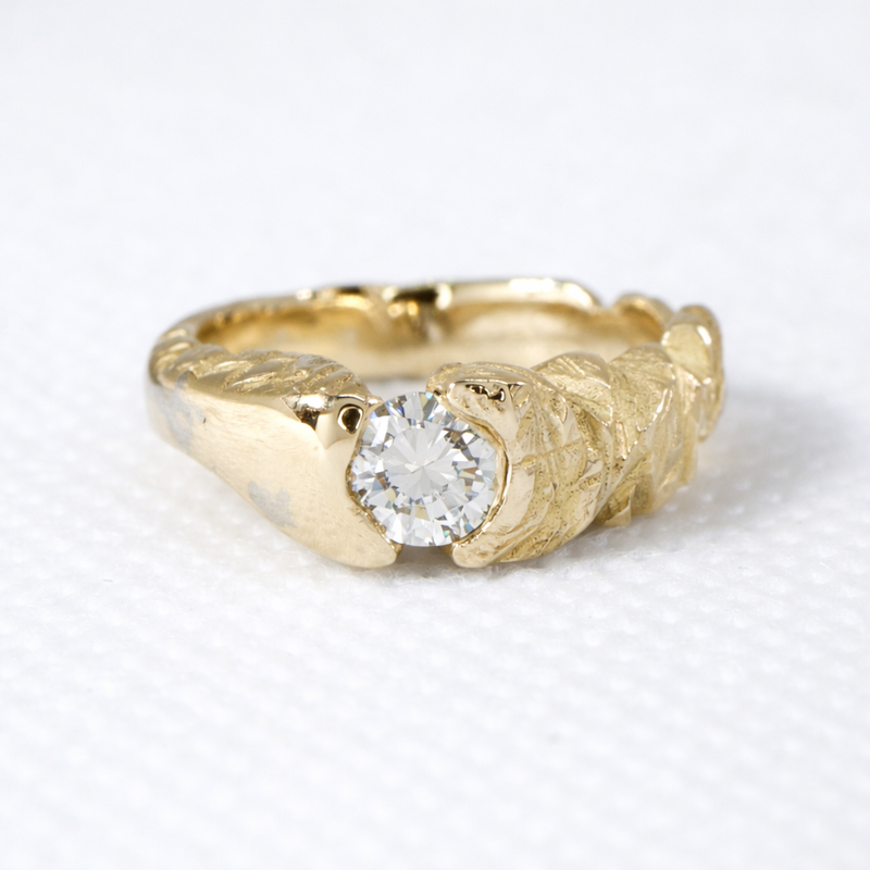 Custom gold ring set with a round brilliant diamond, handcrafted by Alexis Pavlantos with a sculptural, hand-textured band and organic, modern detailing.