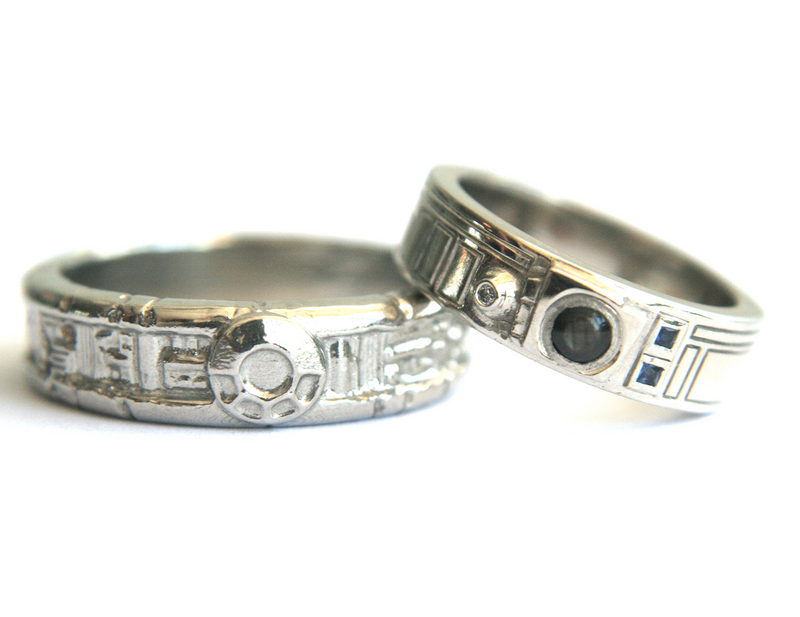 Custom handcrafted metal rings with sculptural, star wars, sci-fi–inspired detailing and inset gemstones, featuring intricate textures and geometric accents, designed and crafted by Alexis Pavlantos.